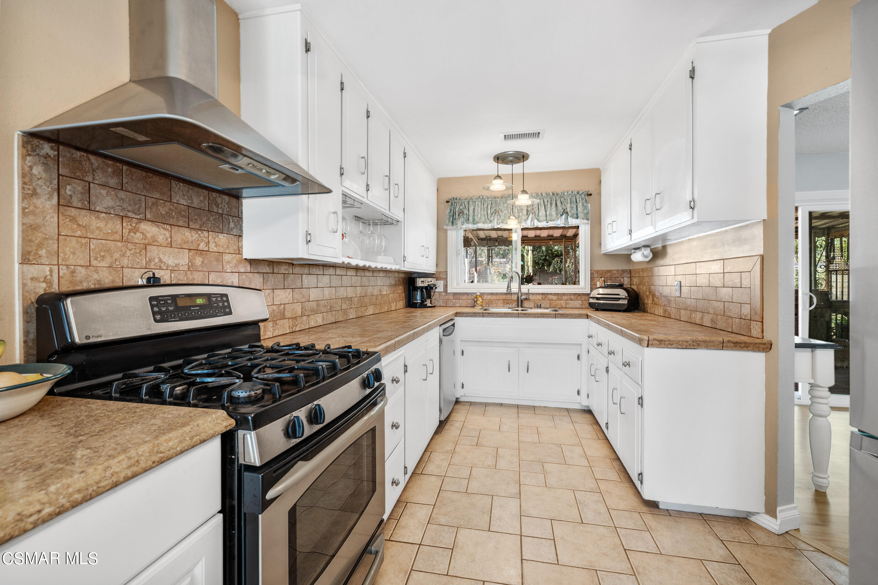 3283 Austin Avenue Simi Valley, CA 93063 - Photo 4 of 30 a kitchen with a sink a stove and a refrigerator
