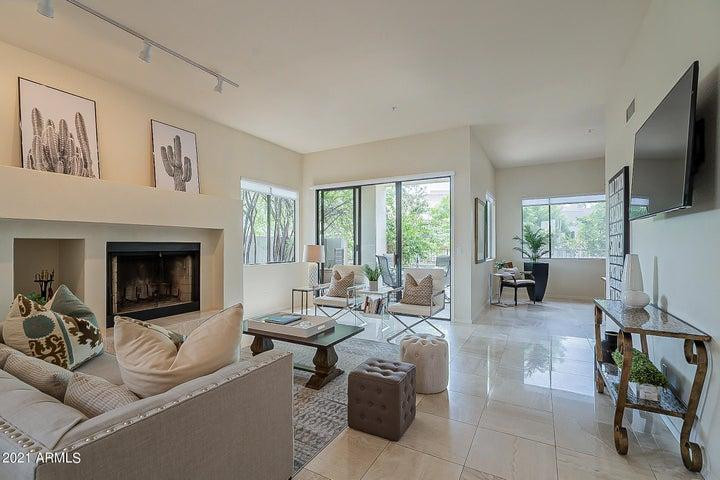 7700 East Gainey Ranch Road, Unit 153 Scottsdale, AZ 85258 - Photo 1 of 24 a living room with furniture large window and a flat screen tv