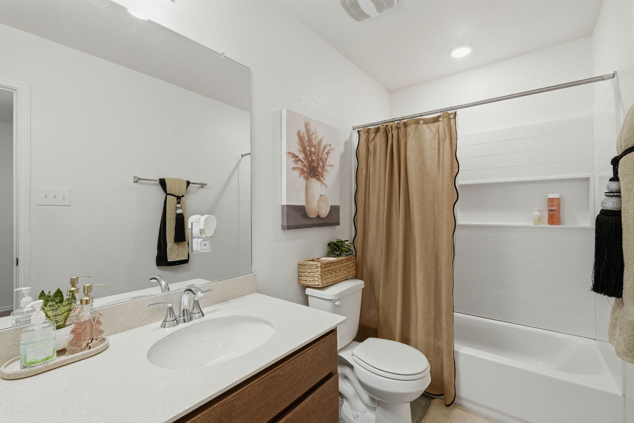 220 Lucky Texan Road Jarrell, TX 76537 - Photo 12 of 19 A pristine bathroom features a single vanity with stone counters and a practical shower-over-tub design.