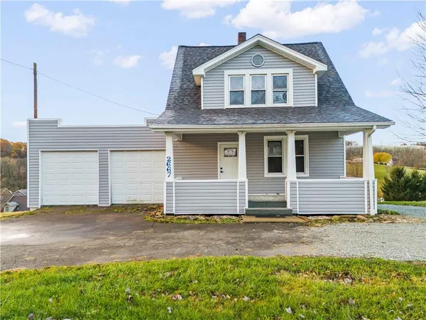 a front view of a house with a yard