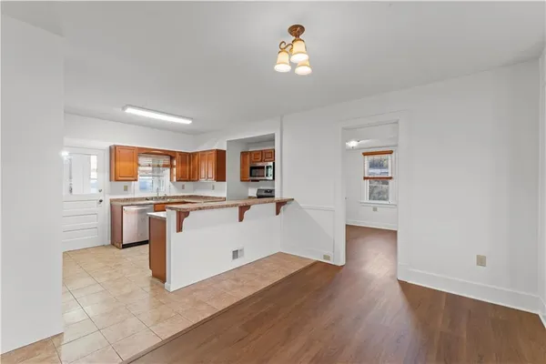 a view of kitchen with wooden floor and electronic appliances