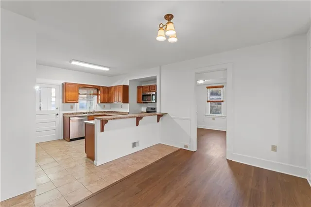 a view of kitchen with wooden floor and electronic appliances