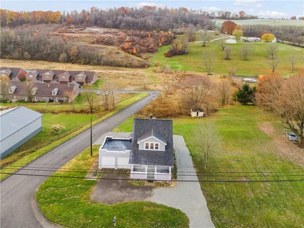 an aerial view of a house with a yard