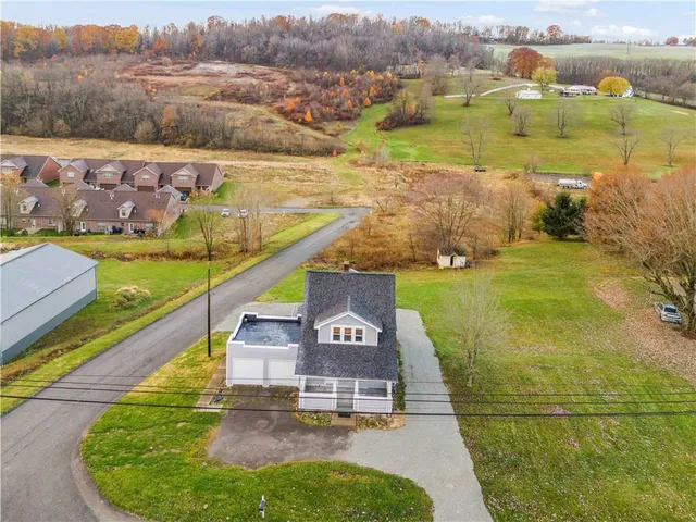 an aerial view of a house with a yard