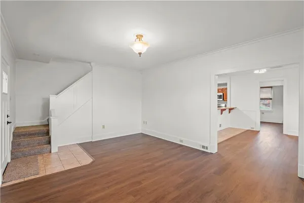 an empty room with wooden floor and closet