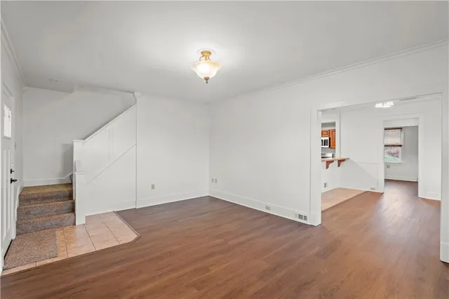 an empty room with wooden floor and closet