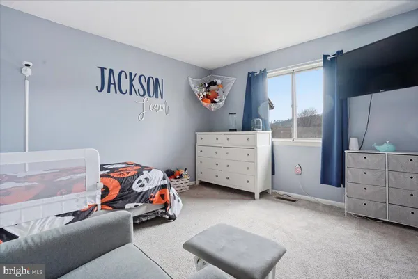 a bedroom with furniture and a window