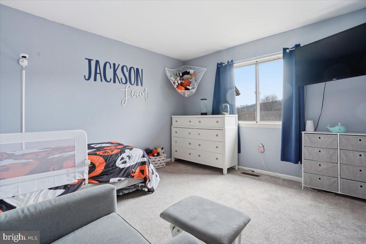 702 Village Road Orwigsburg, PA 17961 - Photo 12 of 27 a bedroom with furniture and a window