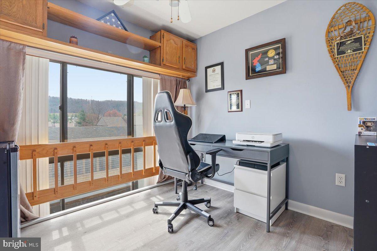 702 Village Road Orwigsburg, PA 17961 - Photo 13 of 27 a view of a workspace with furniture and a window