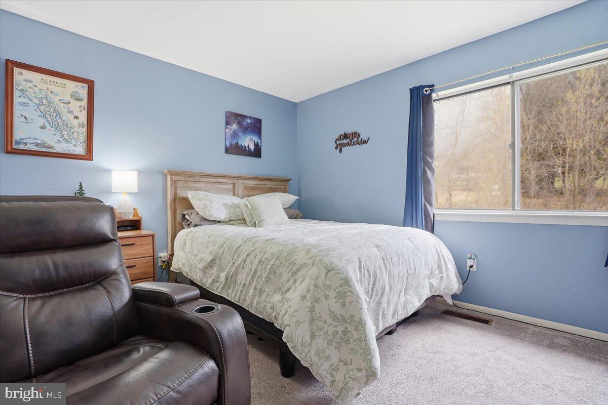 702 Village Road Orwigsburg, PA 17961 - Photo 14 of 27 a bed room with a bed and a couch