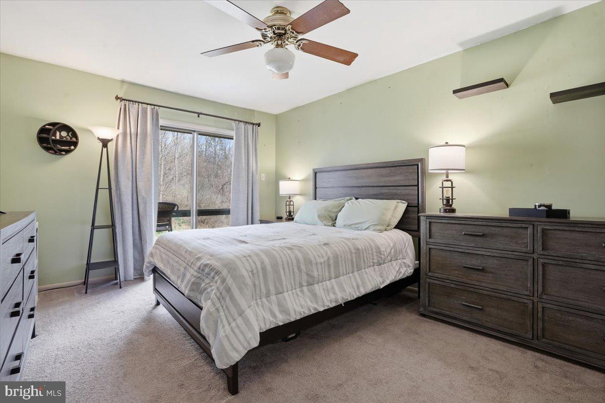 702 Village Road Orwigsburg, PA 17961 - Photo 15 of 27 a bedroom with a large bed and a chandelier