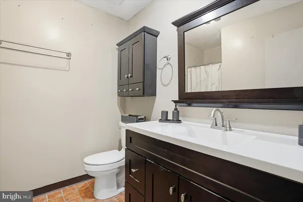 a bathroom with a sink a toilet a mirror and vanity
