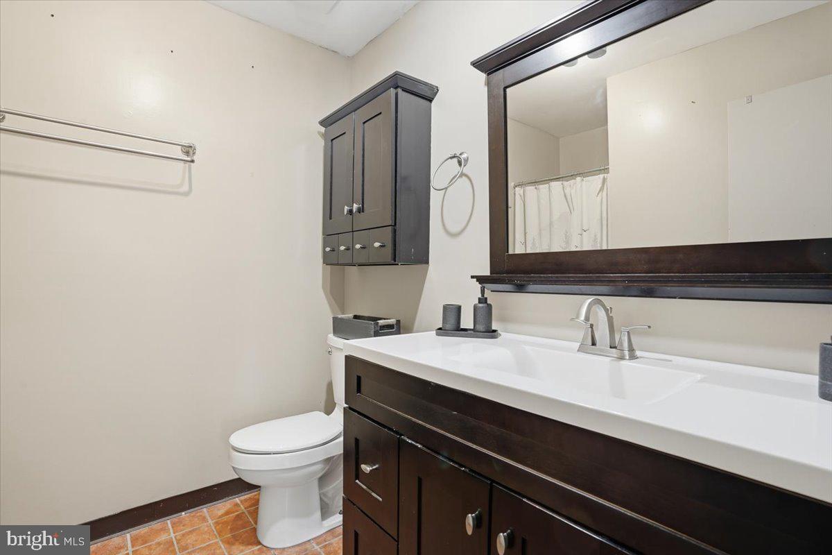 702 Village Road Orwigsburg, PA 17961 - Photo 16 of 27 a bathroom with a sink a toilet a mirror and vanity