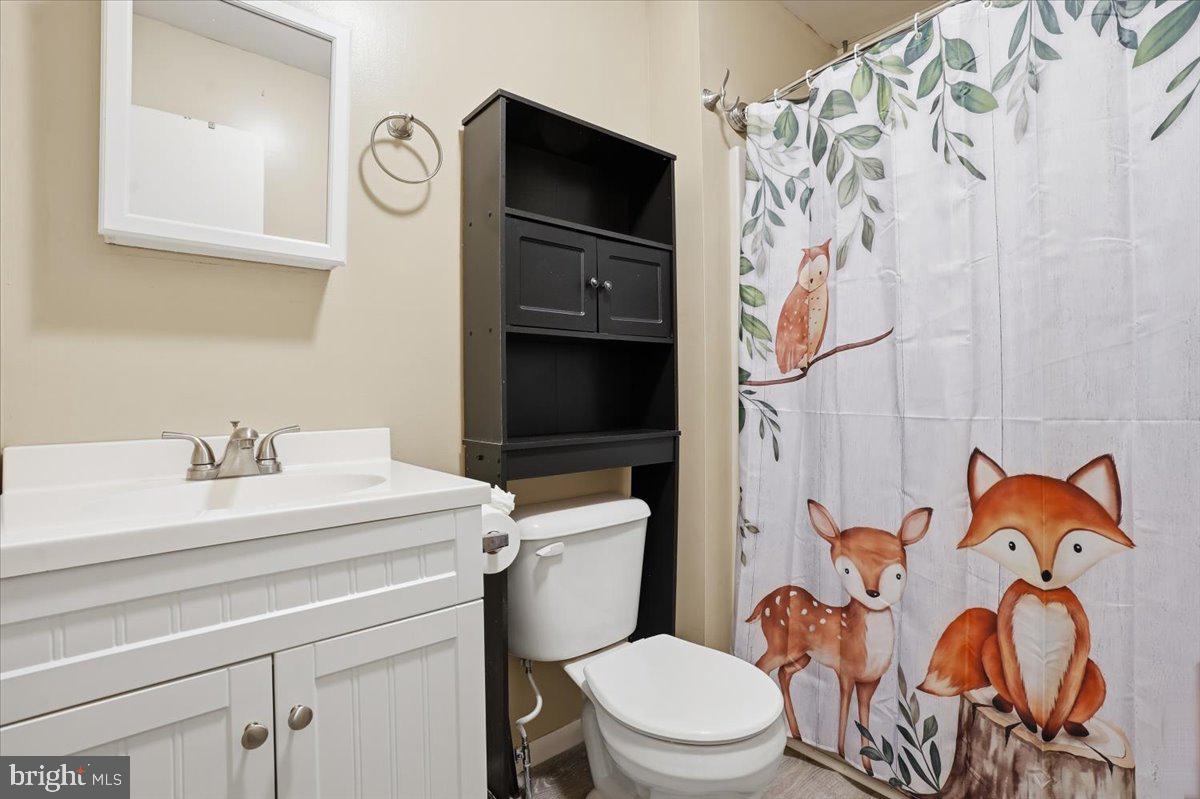 702 Village Road Orwigsburg, PA 17961 - Photo 17 of 27 a bathroom with a toilet sink and mirror