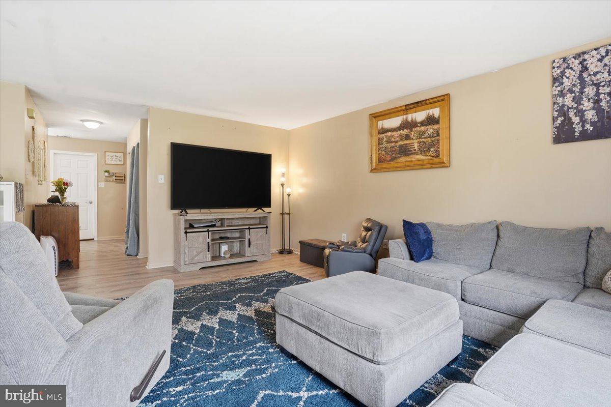 702 Village Road Orwigsburg, PA 17961 - Photo 2 of 27 a living room with furniture and a flat screen tv