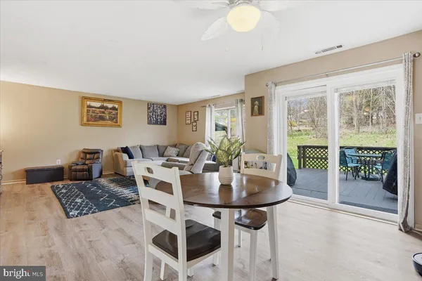 a view of a dining room with furniture and wooden floor