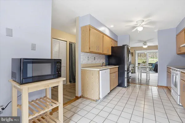 a kitchen with stainless steel appliances a stove a microwave and white cabinets