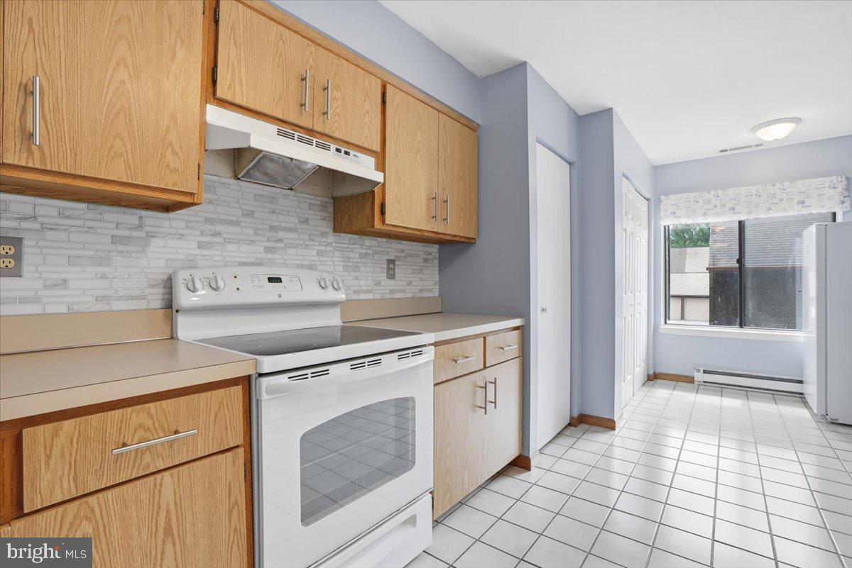 702 Village Road Orwigsburg, PA 17961 - Photo 8 of 27 a kitchen with a stove sink and cabinets