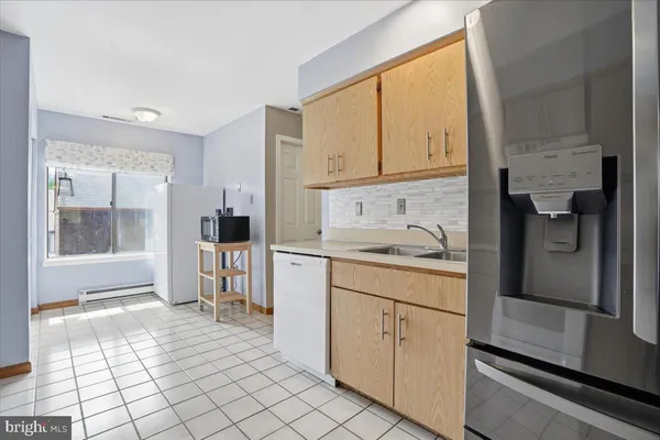 a spacious bathroom with a granite countertop sink a mirror and a shower