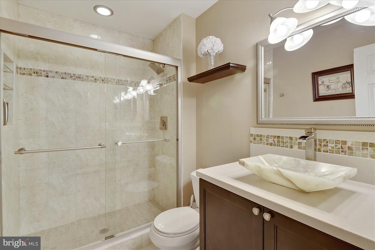 8448 Springfield Oaks Drive Springfield, VA 22153 - Photo 16 of 28 Ceramic tile, glass shower and updated sink