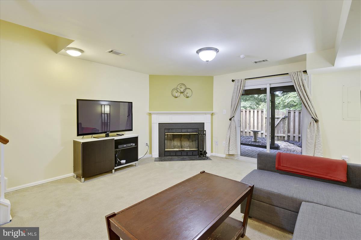 8448 Springfield Oaks Drive Springfield, VA 22153 - Photo 21 of 28 Family room w/ fireplace walks out to backyard