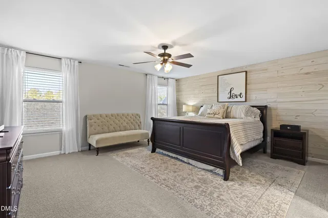 a bedroom with a bed and a ceiling fan