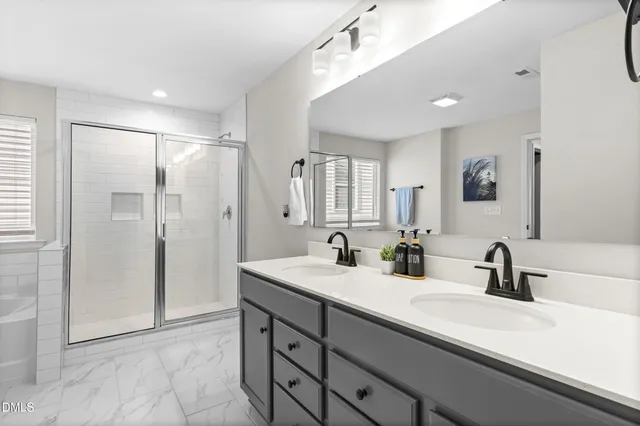 a bathroom with a double vanity sink mirror and shower