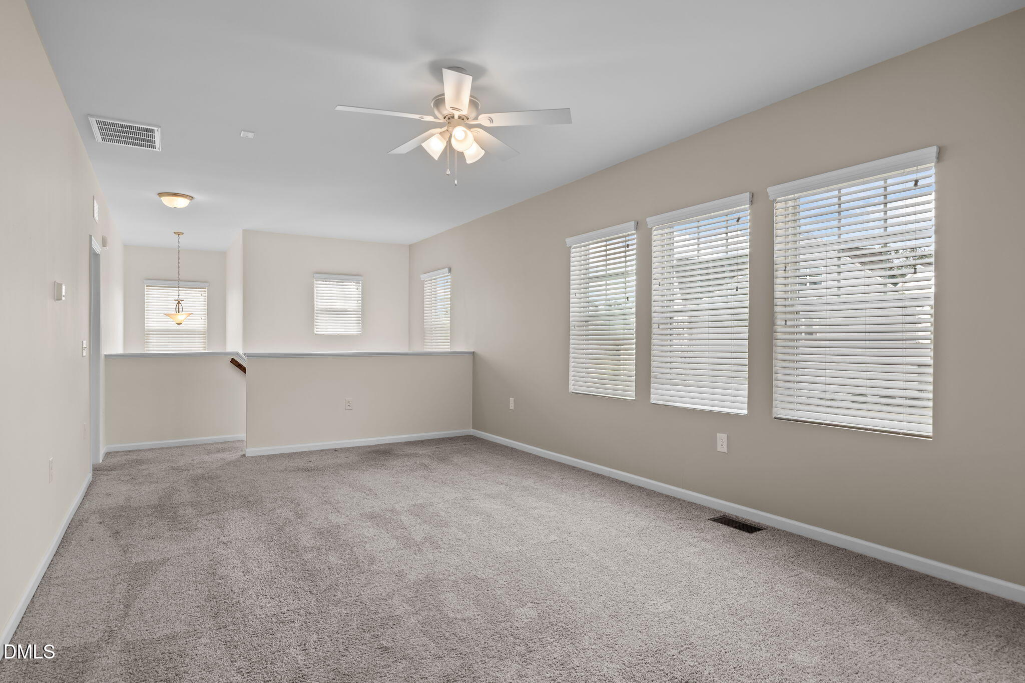 1001 Epiphany Road Morrisville, NC 27560 - Photo 18 of 39 an empty room with windows and chandelier fan