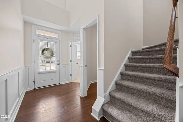 a view of entryway with wooden floor and stairs
