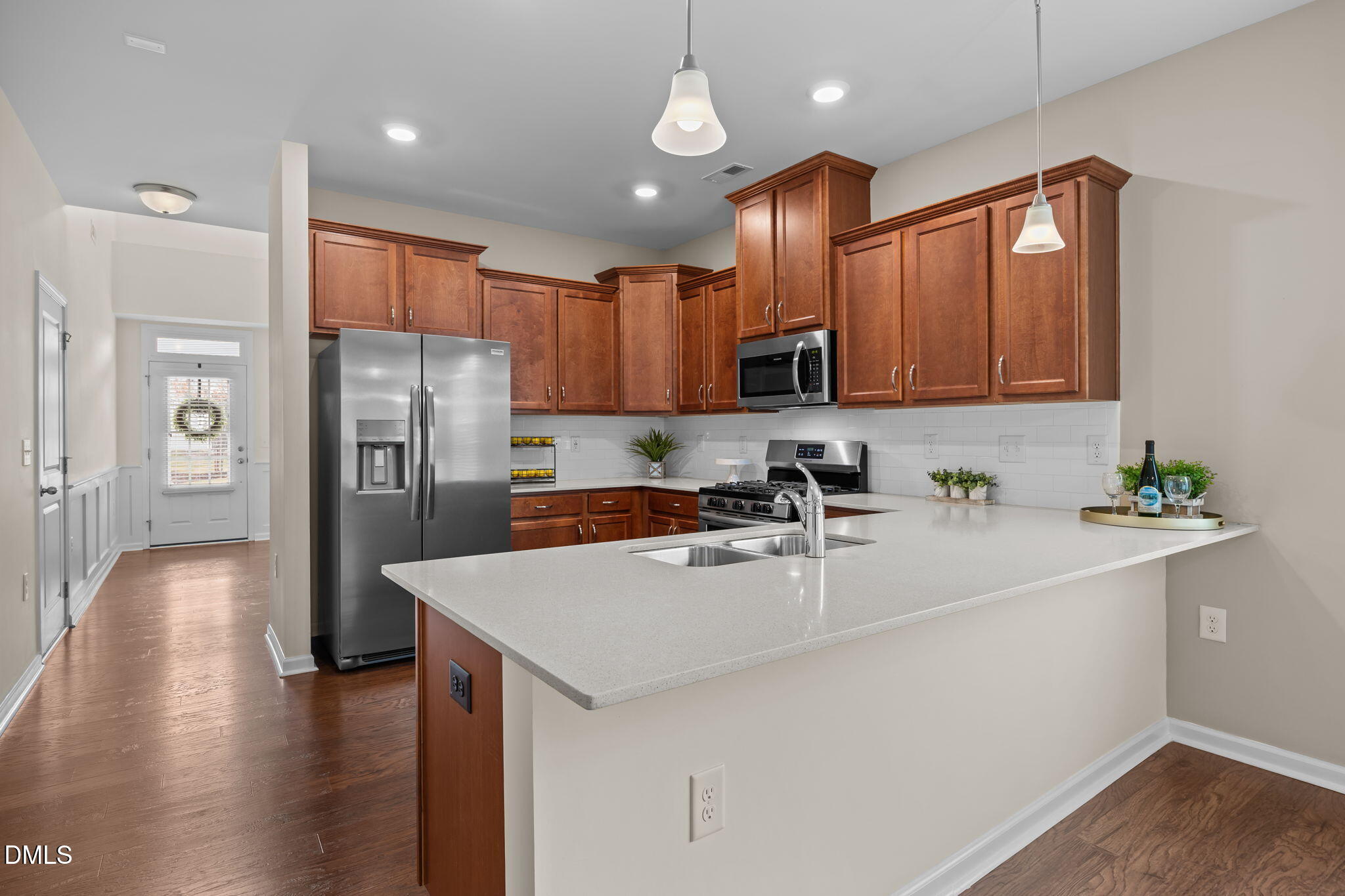 1001 Epiphany Road Morrisville, NC 27560 - Photo 3 of 39 a kitchen with stainless steel appliances a refrigerator sink and wooden cabinets