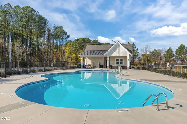 a view of a house with pool and a yard
