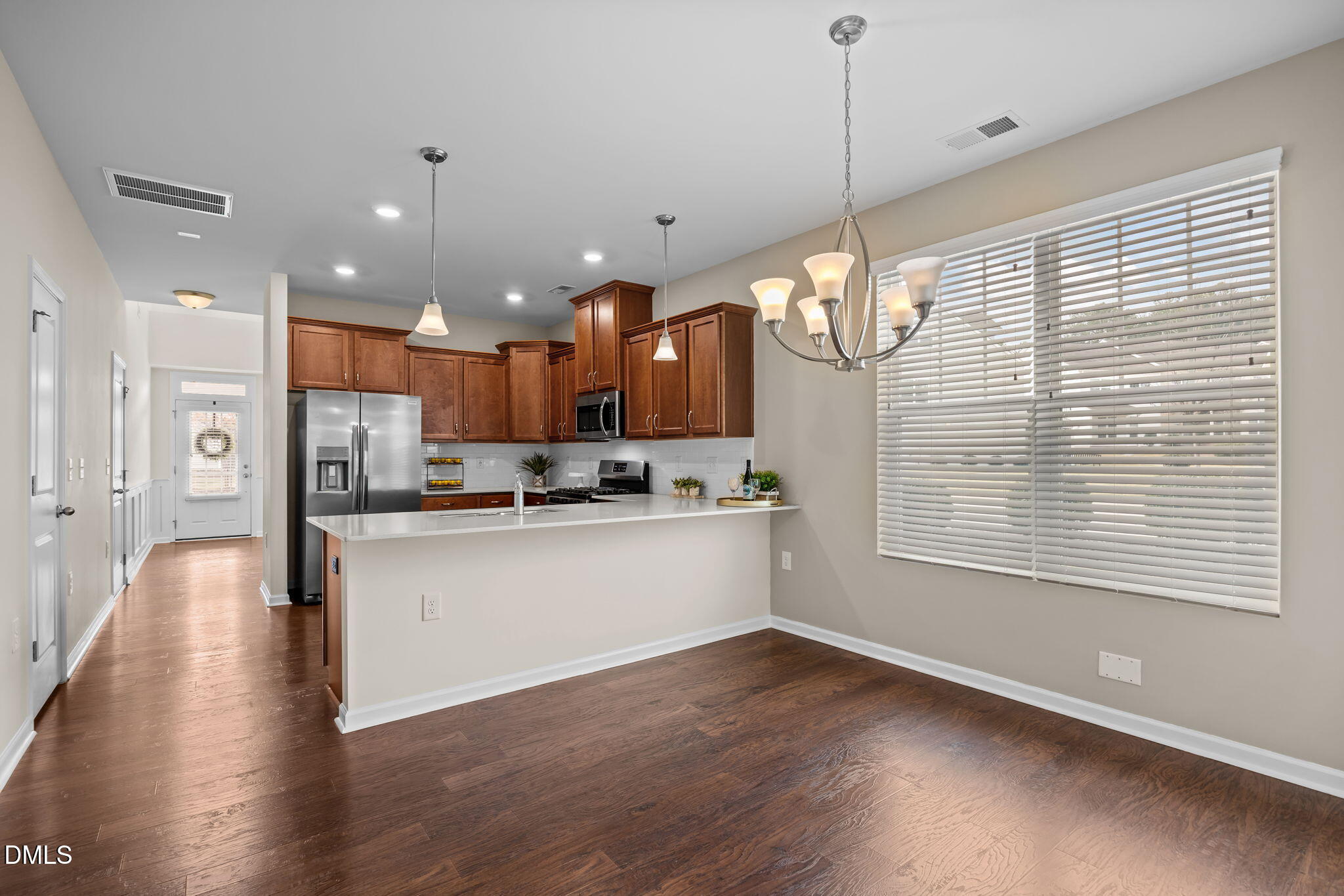 1001 Epiphany Road Morrisville, NC 27560 - Photo 8 of 39 a kitchen with stainless steel appliances granite countertop wooden floors sink and cabinets