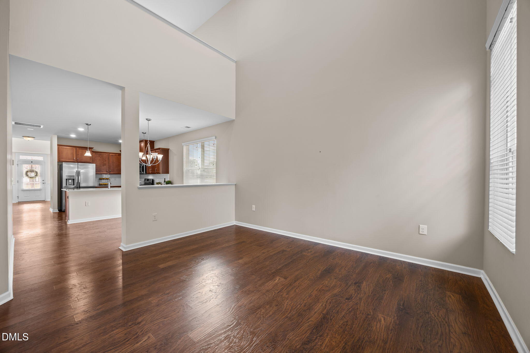 1001 Epiphany Road Morrisville, NC 27560 - Photo 9 of 39 a view of a kitchen and an empty room with wooden floor