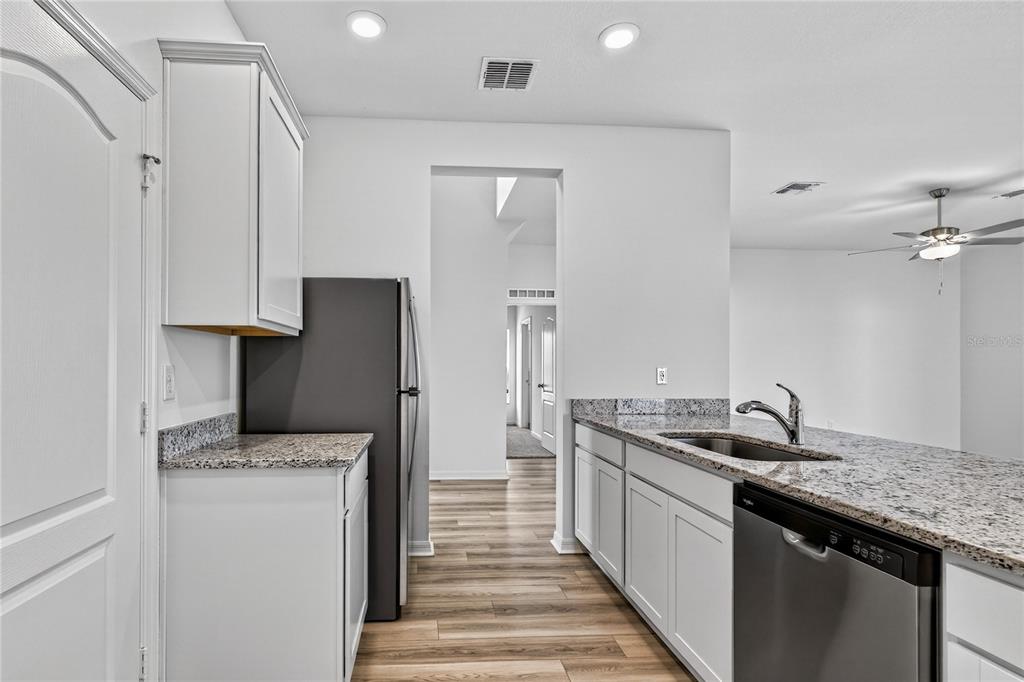 13430 Leaping Water Way Astatula, FL 34705 - Photo 18 of 55 a kitchen with a sink and a refrigerator