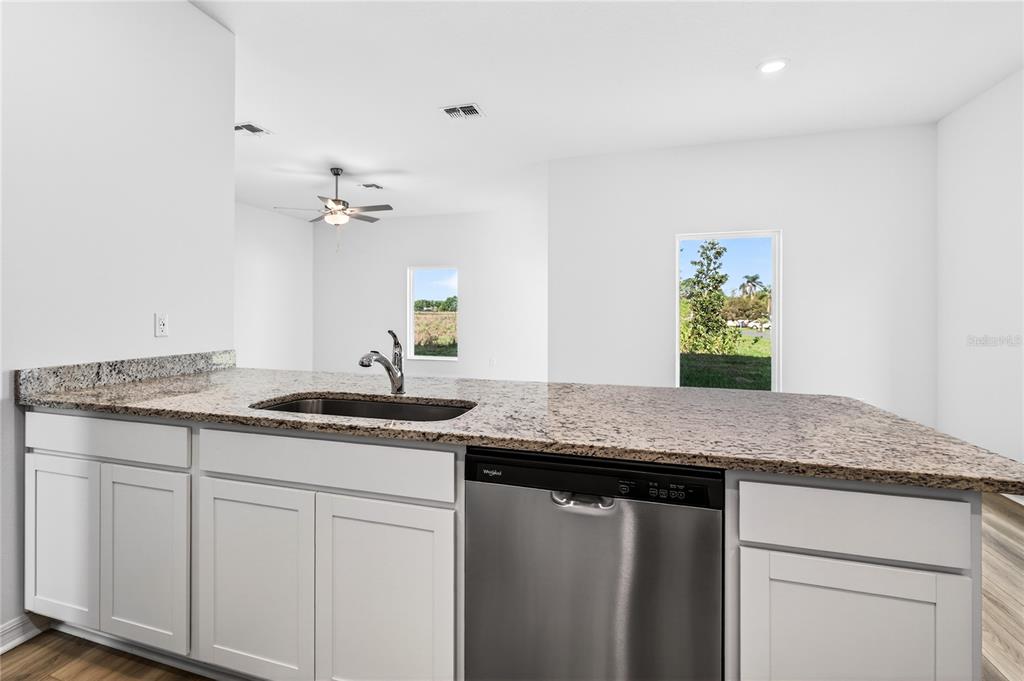 13430 Leaping Water Way Astatula, FL 34705 - Photo 19 of 55 a bathroom with a granite countertop sink and a mirror