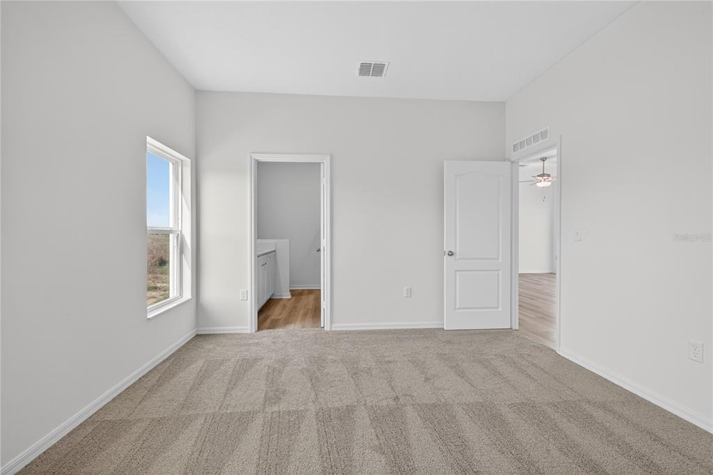 13430 Leaping Water Way Astatula, FL 34705 - Photo 22 of 55 a view of an empty room with a window
