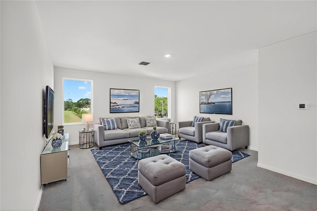 13430 Leaping Water Way Astatula, FL 34705 - Photo 27 of 55 a living room with furniture a couch and a flat screen tv