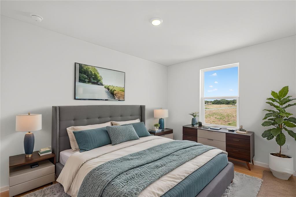 13430 Leaping Water Way Astatula, FL 34705 - Photo 37 of 55 a bedroom with a bed and a potted plant