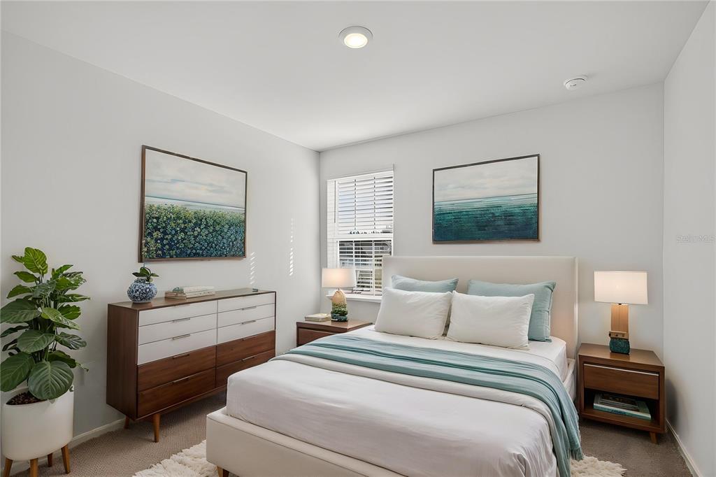 13430 Leaping Water Way Astatula, FL 34705 - Photo 39 of 55 a bedroom with a bed and a potted plant