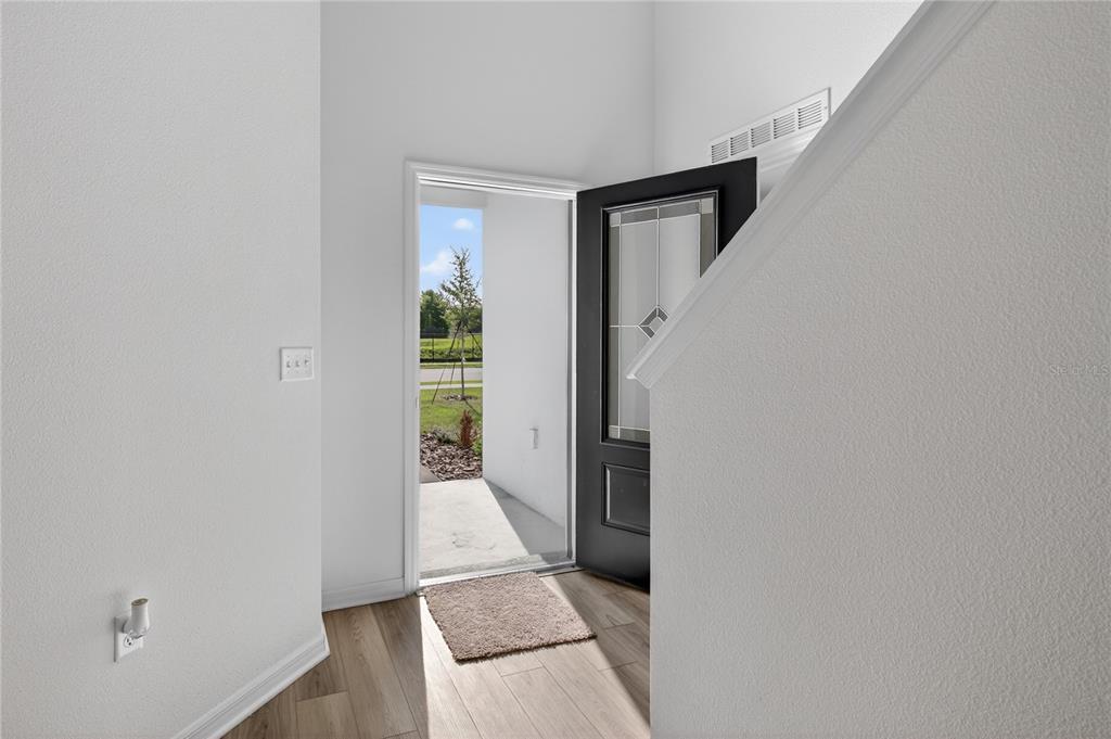 13430 Leaping Water Way Astatula, FL 34705 - Photo 4 of 55 a view of an entryway with wooden floor