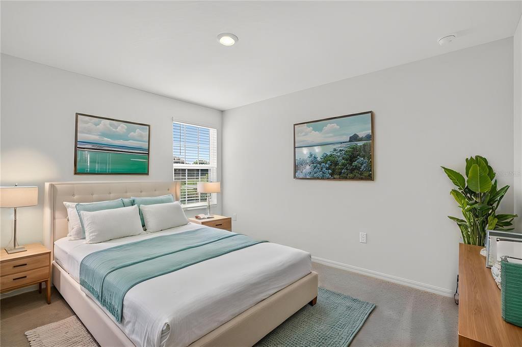 13430 Leaping Water Way Astatula, FL 34705 - Photo 41 of 55 a bedroom with a large bed and a potted plant