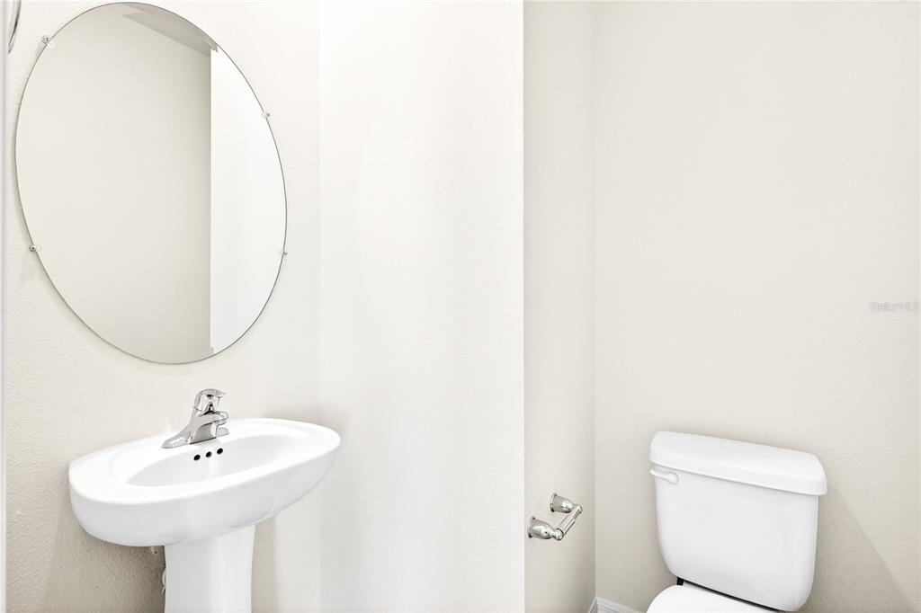 13430 Leaping Water Way Astatula, FL 34705 - Photo 43 of 55 a bathroom with a sink a toilet and a mirror