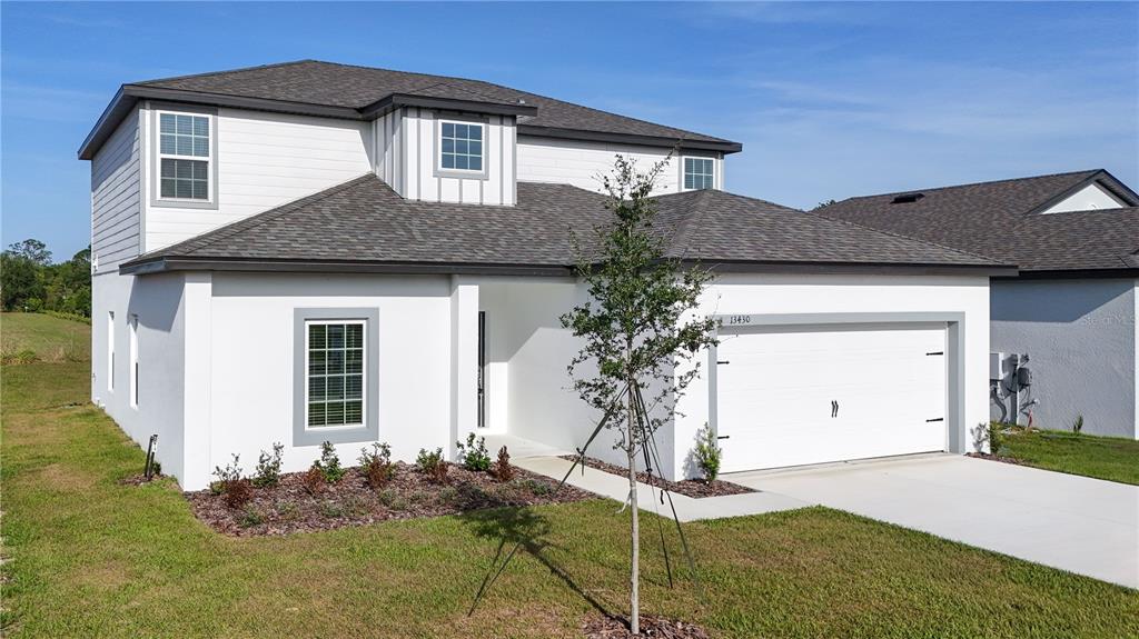 13430 Leaping Water Way Astatula, FL 34705 - Photo 49 of 55 a front view of a house with a yard