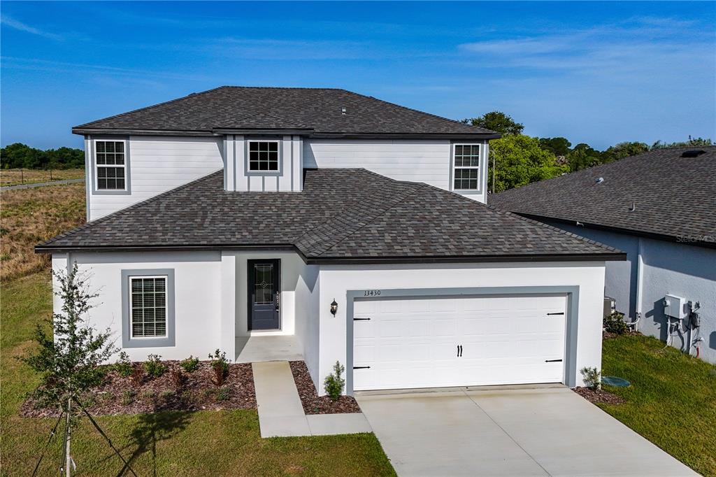 13430 Leaping Water Way Astatula, FL 34705 - Photo 50 of 55 a front view of a house with a yard