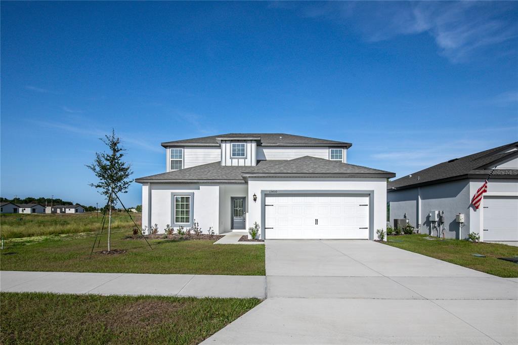 13430 Leaping Water Way Astatula, FL 34705 - Photo 51 of 55 a front view of a house with a garden