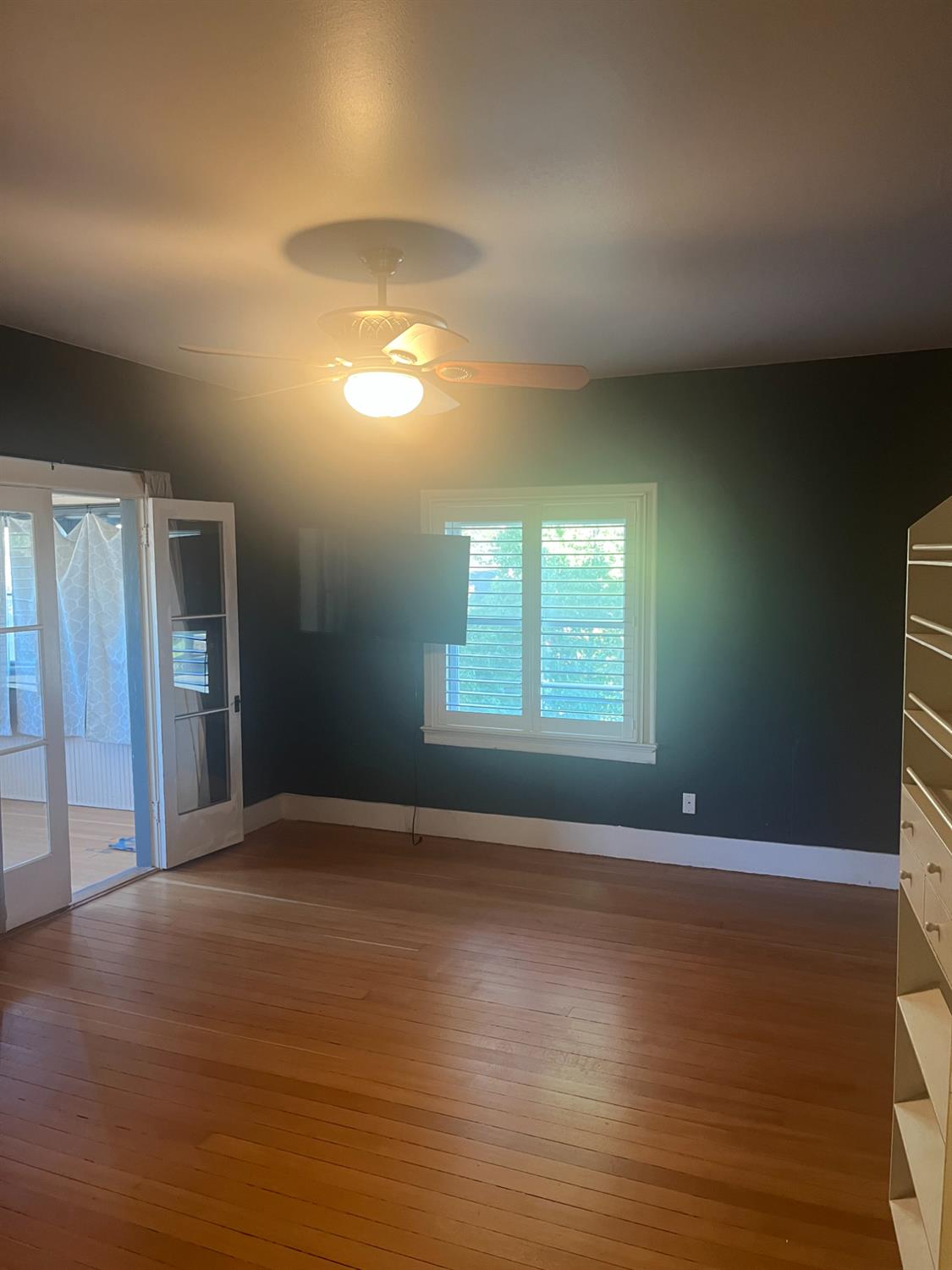 1205 P Street Newman, CA 95360 - Photo 1 of 6 a view of an empty room with wooden floor and a window