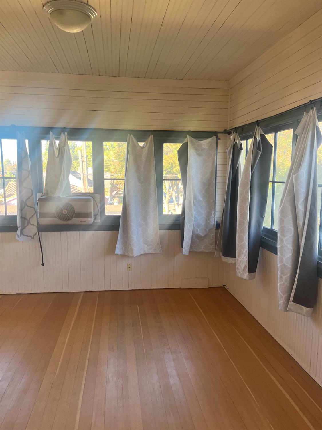1205 P Street Newman, CA 95360 - Photo 5 of 6 a view of empty room with wooden floor and fan