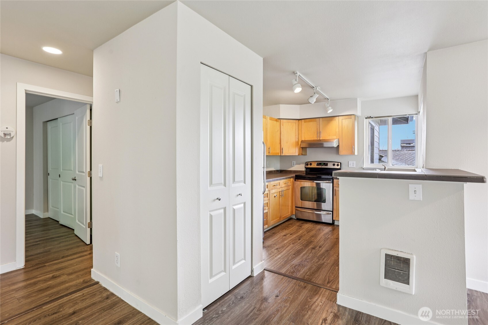 3927 243rd Place Southeast, Unit I304 Bothell, WA 98021 - Photo 13 of 28 a kitchen with cabinets and wooden floor