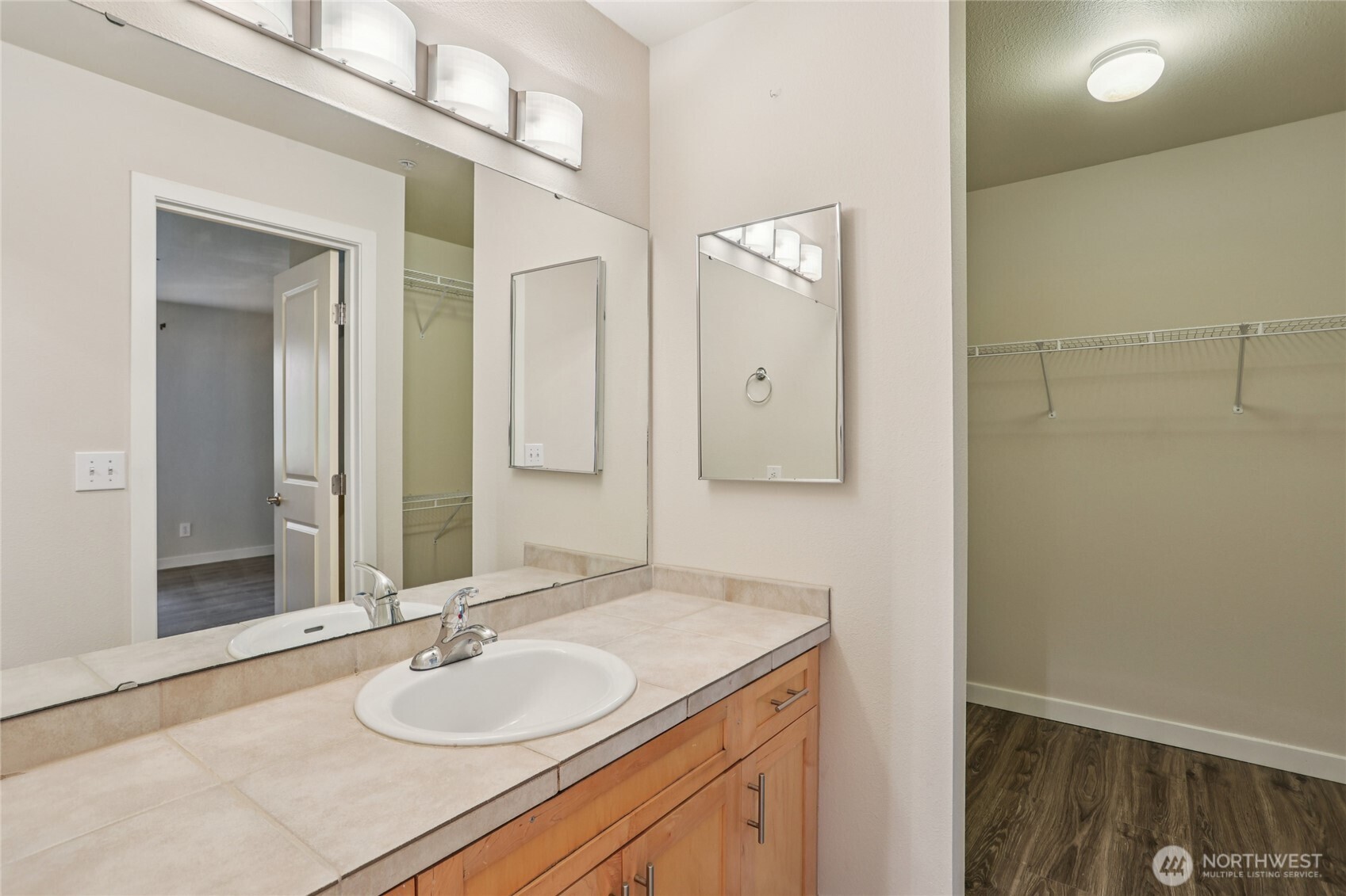 3927 243rd Place Southeast, Unit I304 Bothell, WA 98021 - Photo 16 of 28 a bathroom with a granite countertop sink and a mirror