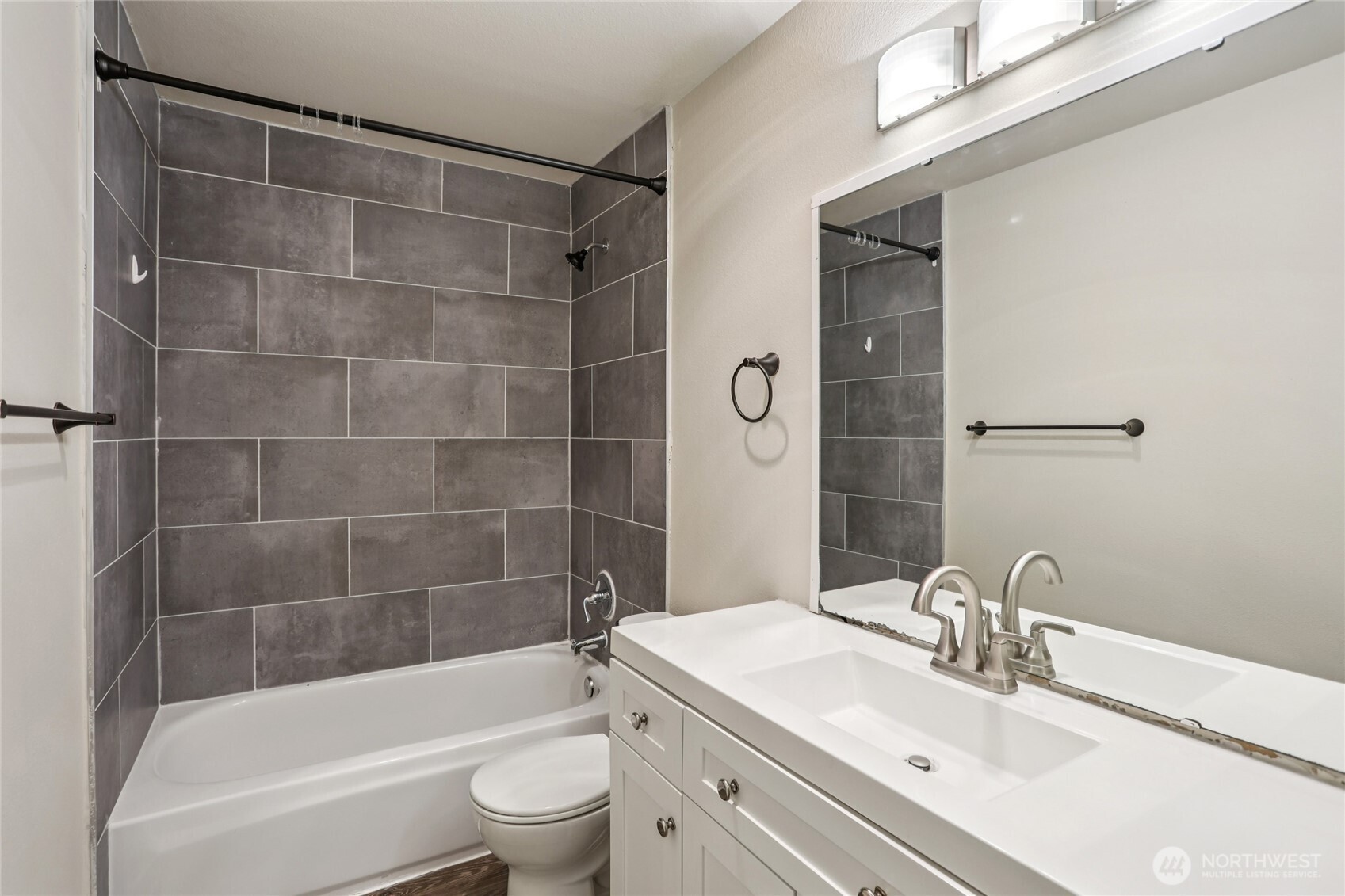 3927 243rd Place Southeast, Unit I304 Bothell, WA 98021 - Photo 18 of 28 a bathroom with a bathtub shower sink vanity and toilet